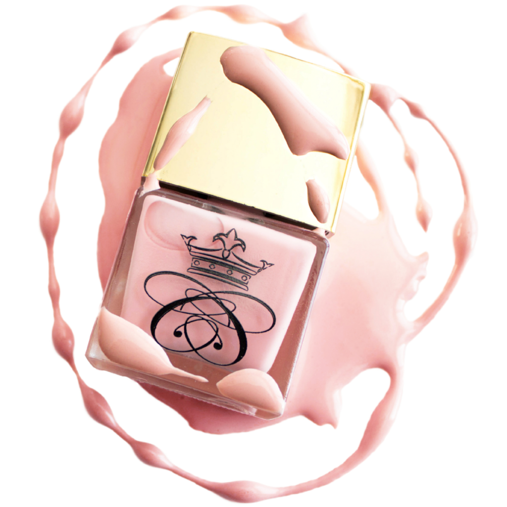 square glass nail polish bottle with baby pink nail polish with gold cap and nail polish drippings and smears on white isolated background
