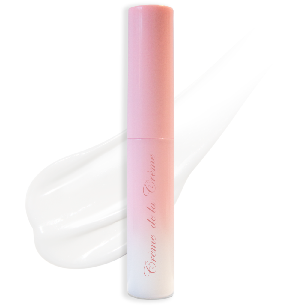 Eyelashes, Latex Free eyelash glue in pink to white gradient plastic tube with white glue smudge in backgroun