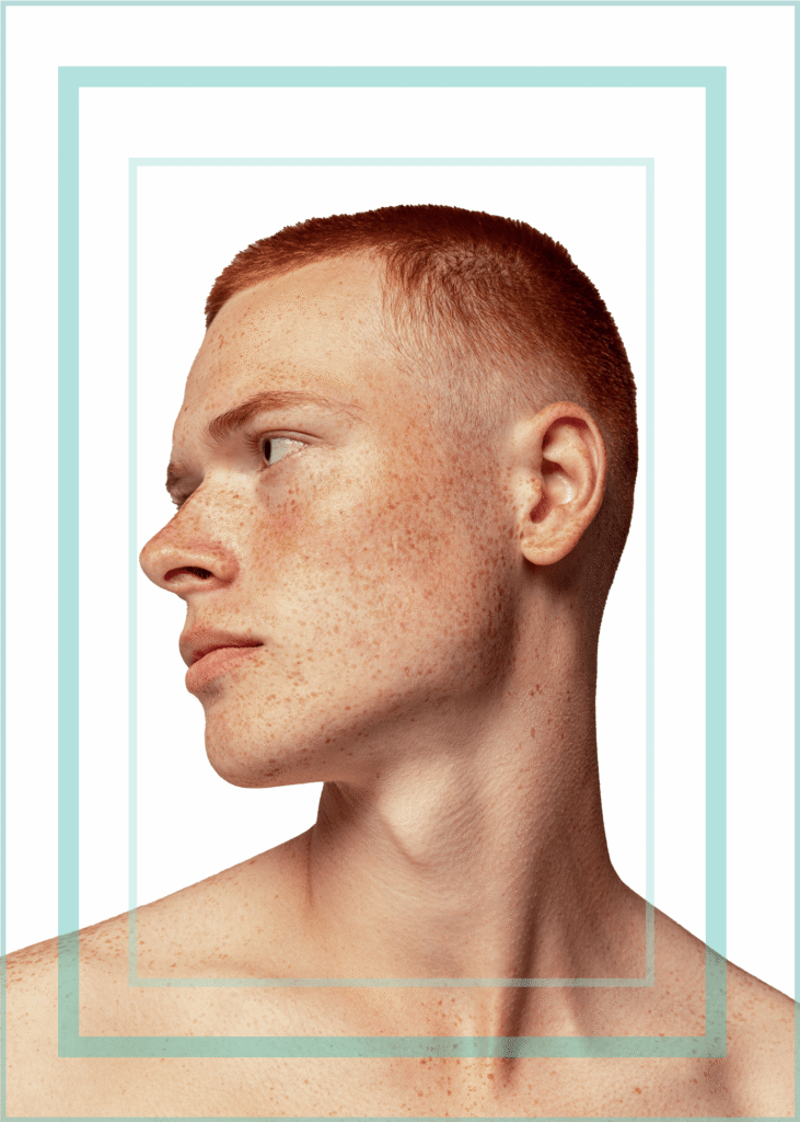 Men's Grooming portrait of profile of handsome red haired man with freckles on white isolated background with light blue decorative border